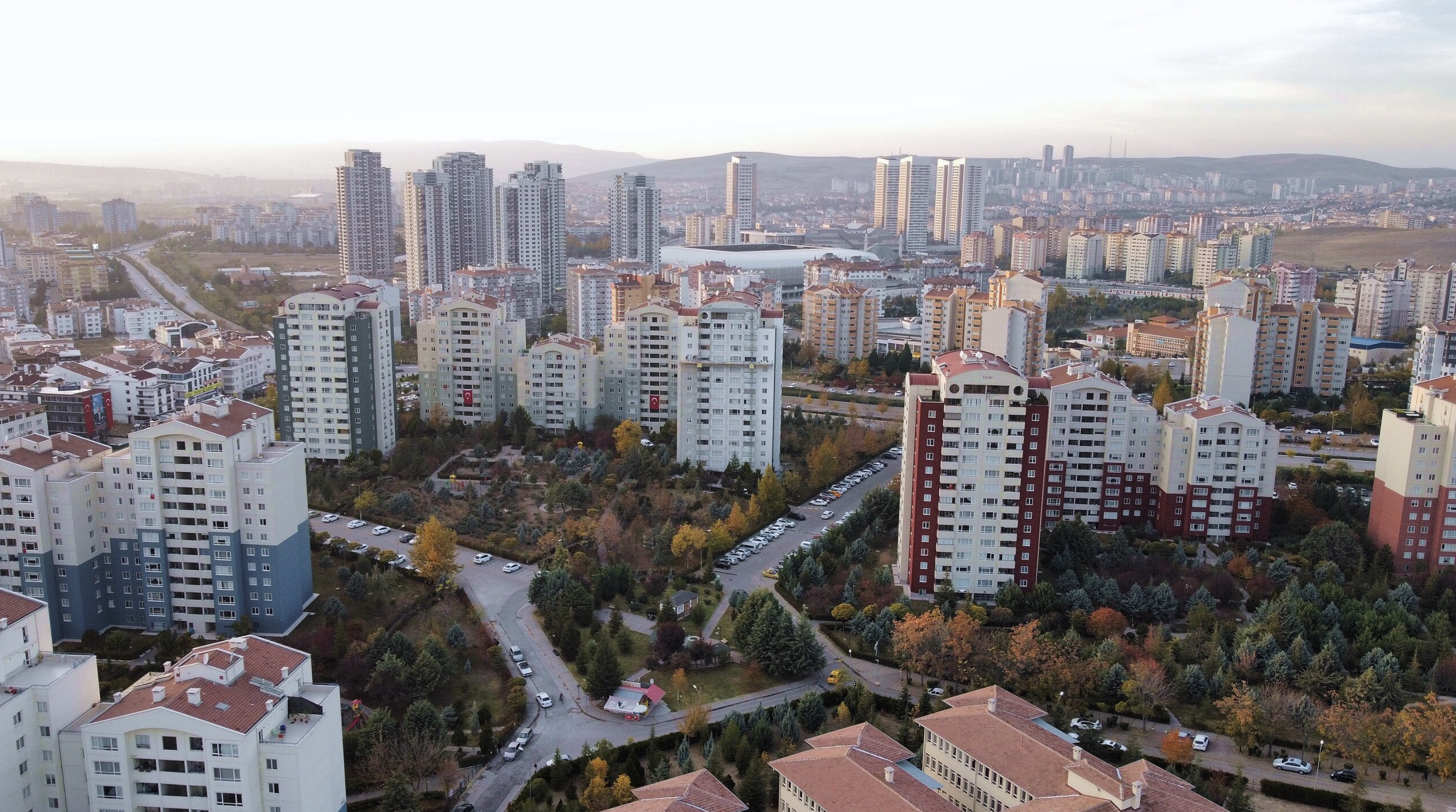 Ankara's peri-urban landscape: high-rise residential towers scattered across a dispersed urban fabric with fragmented green spaces
